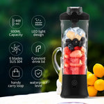 Portable blender with fruits inside, features listed on the left, against a blurred green background.